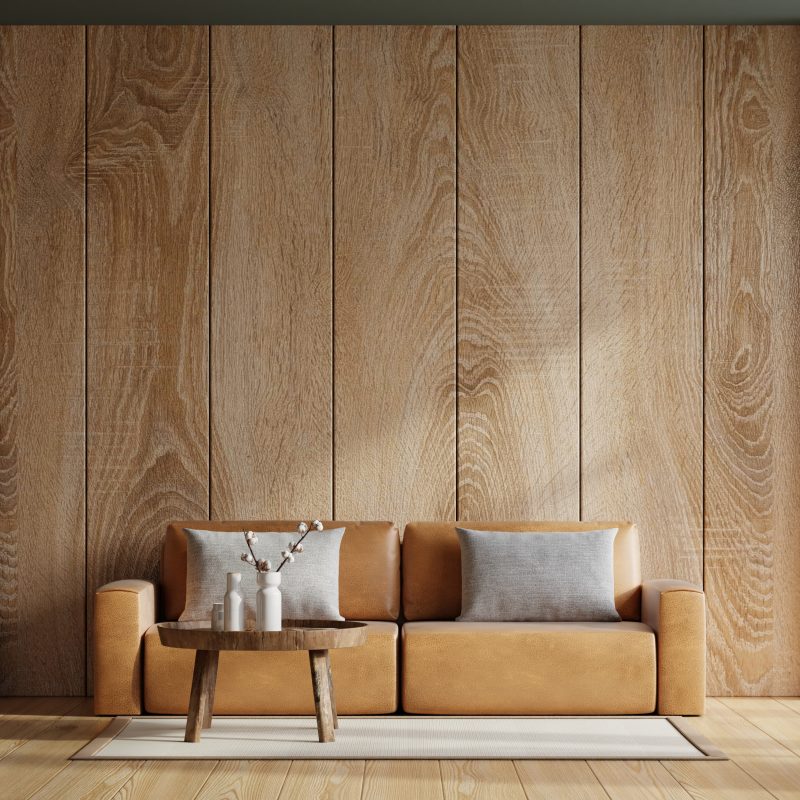 Interior living room wall mockup with leather sofa and decor on wooden wall background